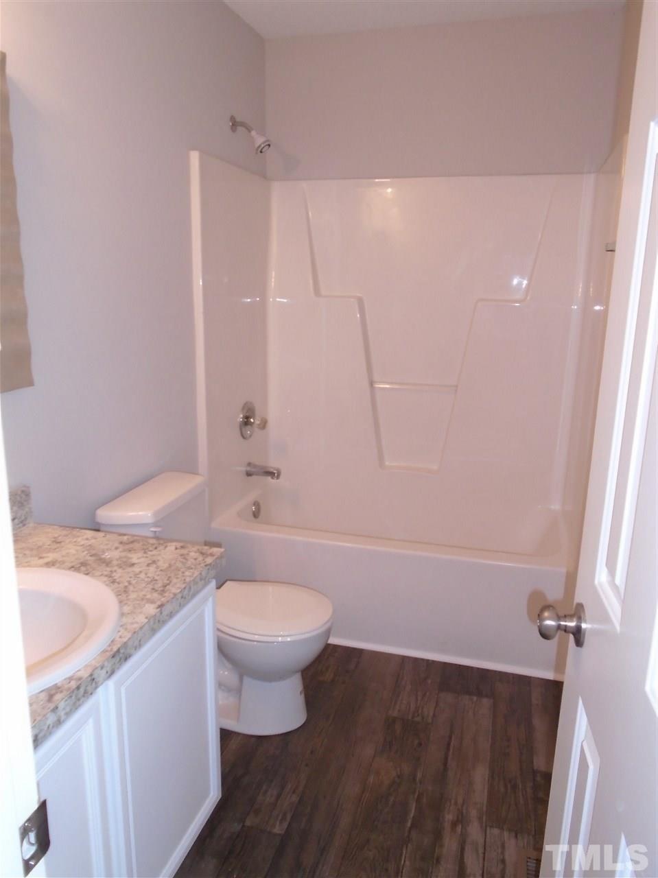 289 Wagner Road Willow Spring, NC 27592 - Photo 11 of 12 a bathroom with a sink a toilet and shower