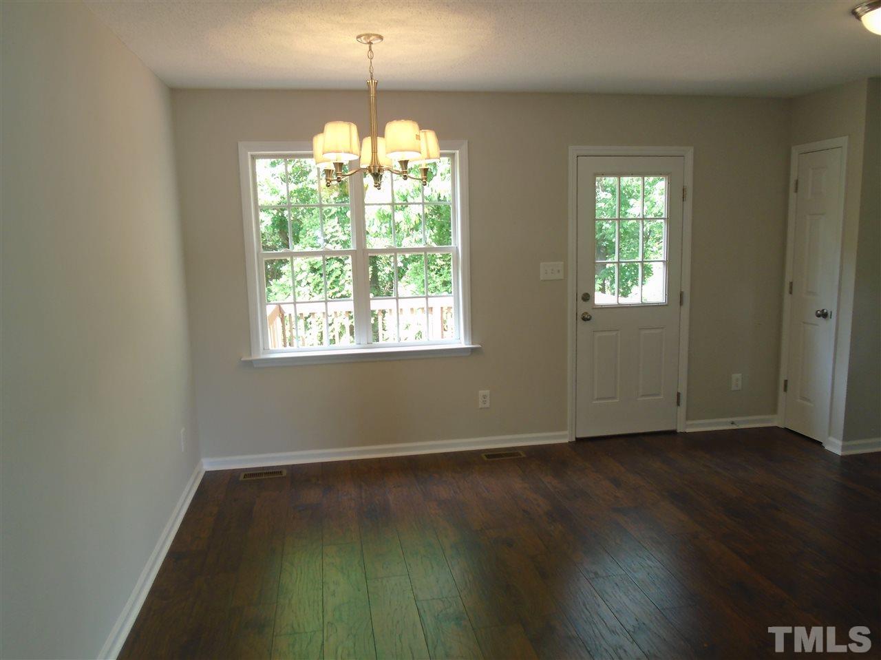 289 Wagner Road Willow Spring, NC 27592 - Photo 6 of 12 a view of an empty room with wooden floor and a window