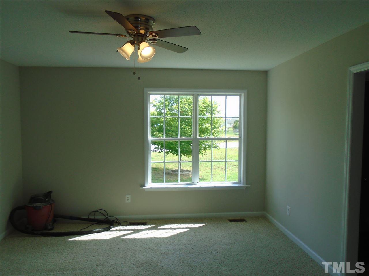 289 Wagner Road Willow Spring, NC 27592 - Photo 10 of 12 a room with window and ceiling fan