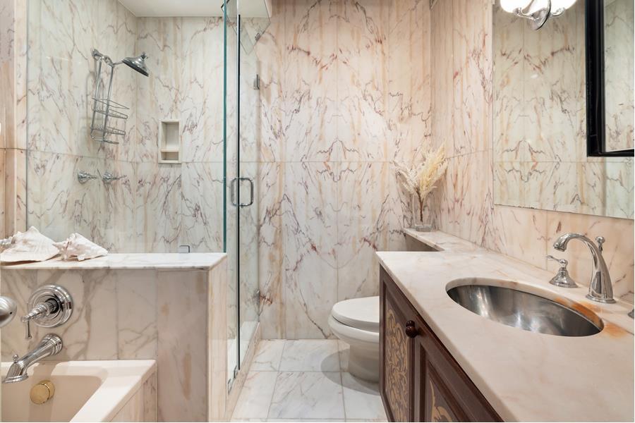 530 East 76th Street, Unit 21HJK Manhattan, NY 10021 - Photo 10 of 21 a bathroom with a sink a toilet and shower