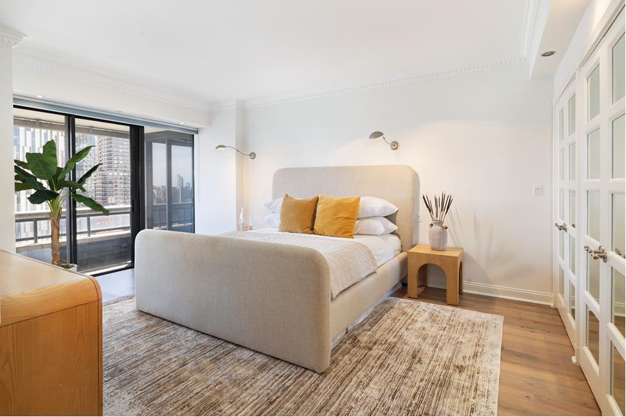 530 East 76th Street, Unit 21HJK Manhattan, NY 10021 - Photo 11 of 21 a bedroom with a large bed and a large window