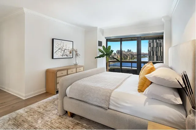 a bedroom with a large bed and a large window