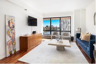 530 East 76th Street, Unit 21HJK Manhattan, NY 10021 - Photo 14 of 21 a living room with furniture and a flat screen tv