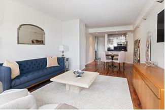 530 East 76th Street, Unit 21HJK Manhattan, NY 10021 - Photo 15 of 21 a living room with furniture and a wooden floor