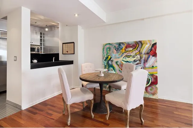 a kitchen with white cabinets and appliances