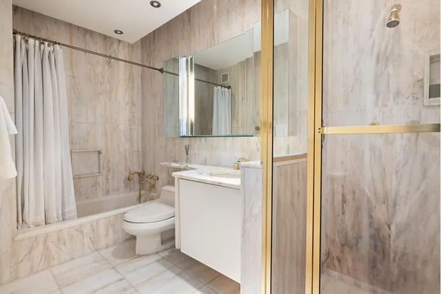 a bedroom with a bed a mirror and table