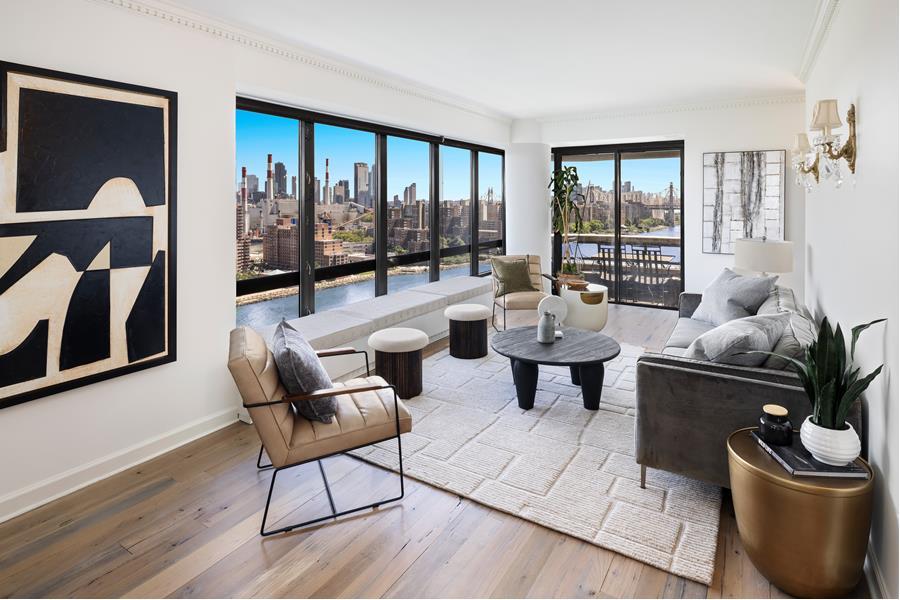 530 East 76th Street, Unit 21HJK Manhattan, NY 10021 - Photo 2 of 21 a living room with furniture and a floor to ceiling window