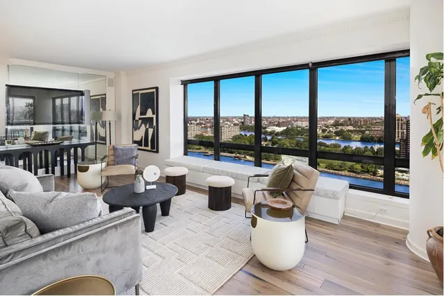 a living room with furniture and a floor to ceiling window