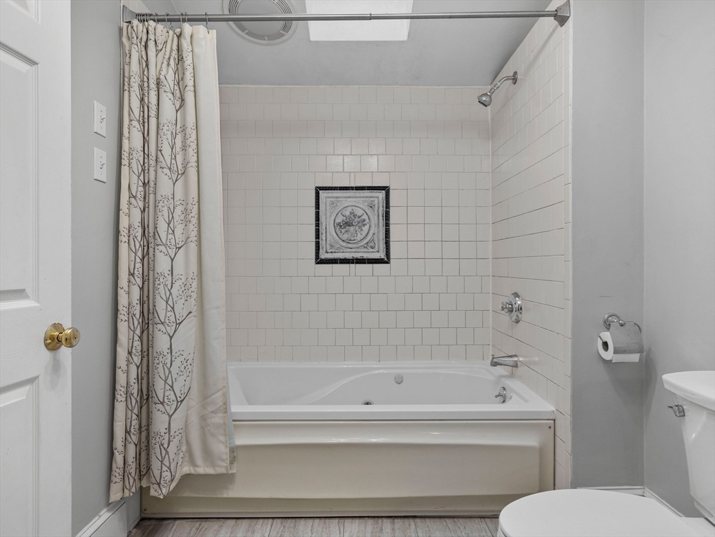 55 Kellogg Street Framingham, MA 01701 - Photo 26 of 42 a bathroom with a toilet and a bathtub