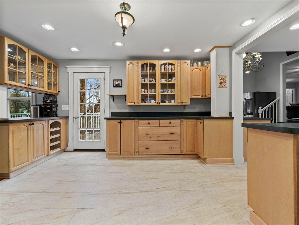 55 Kellogg Street Framingham, MA 01701 - Photo 10 of 42 a view of a kitchen with stainless steel appliances granite countertop a large window