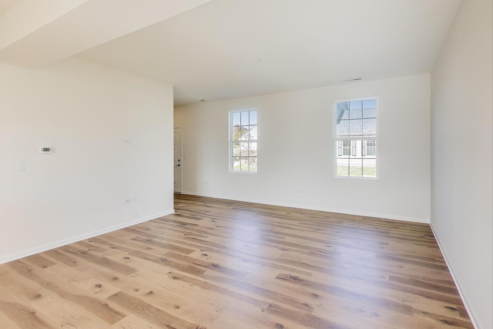 1003 Celebration Drive Aurora, IL 60504 - Photo 11 of 35 an empty room with wooden floor and window