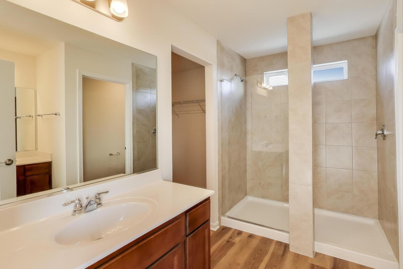 1003 Celebration Drive Aurora, IL 60504 - Photo 14 of 35 a bathroom with a sink and a mirror