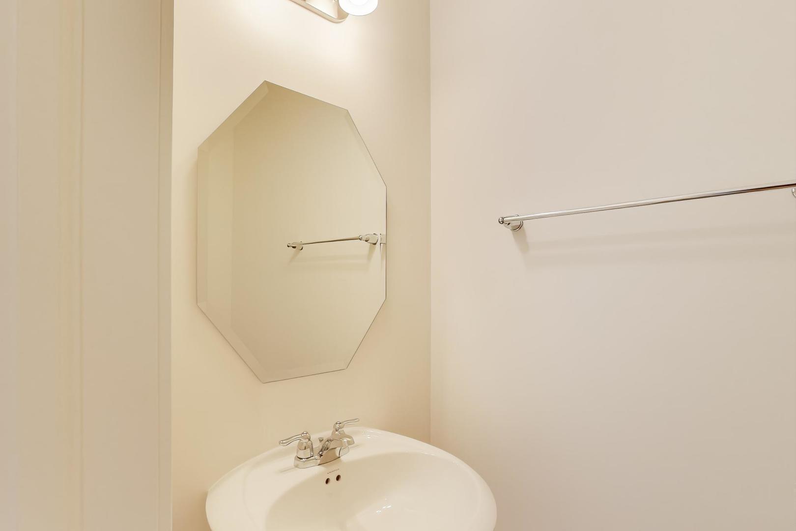 1003 Celebration Drive Aurora, IL 60504 - Photo 19 of 35 a bathroom with a sink and mirror