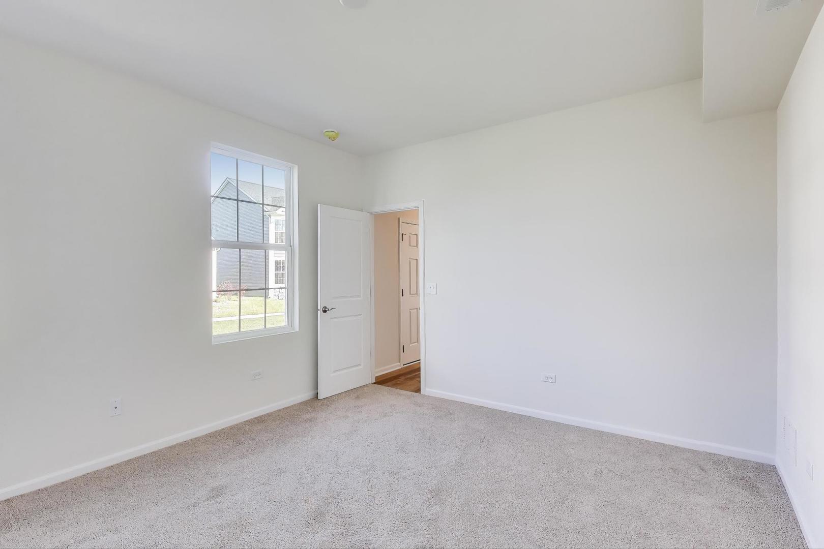 1003 Celebration Drive Aurora, IL 60504 - Photo 21 of 35 an empty room with windows