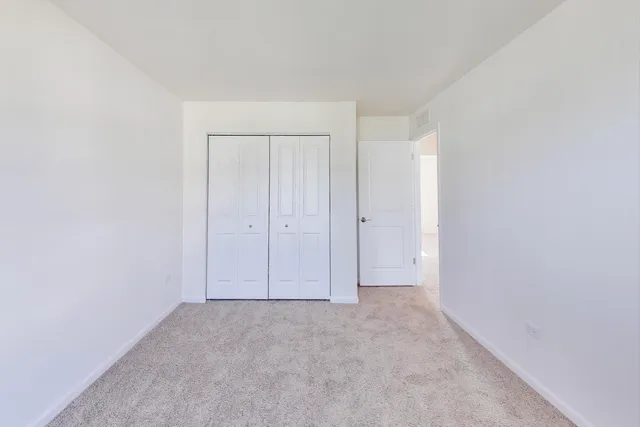 a view of a pathway both side of grassy field with shrub