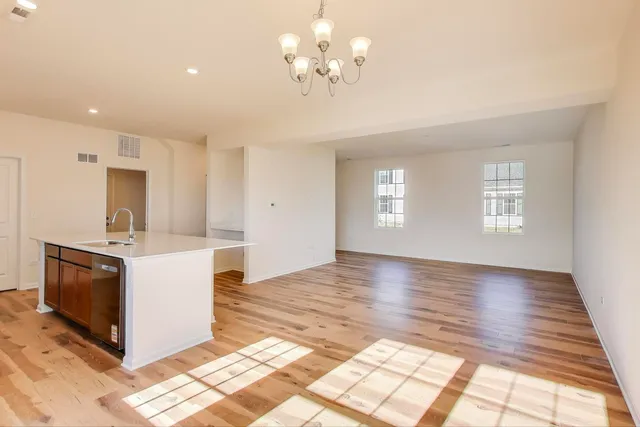 a view of a kitchen with a stove cabinets and a floor to ceiling window