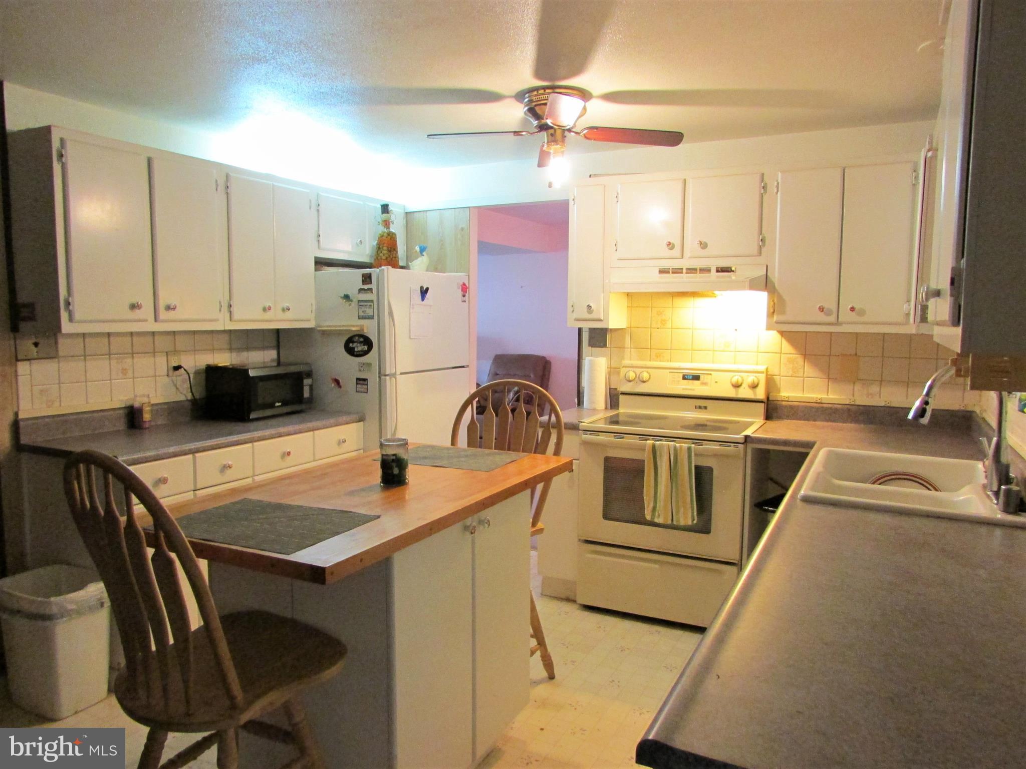 124 Redbud Road Edgewood, MD 21040 - Photo 4 of 12 a kitchen with a stove a sink and a refrigerator