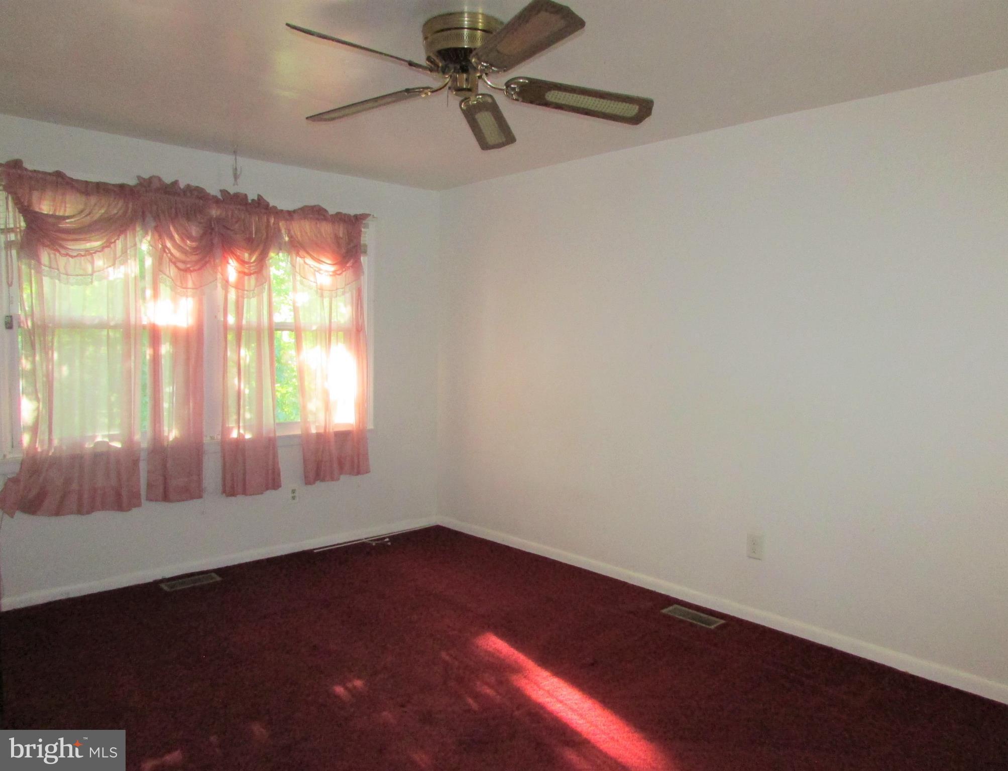 124 Redbud Road Edgewood, MD 21040 - Photo 10 of 12 en empty room with windows and ceiling fan