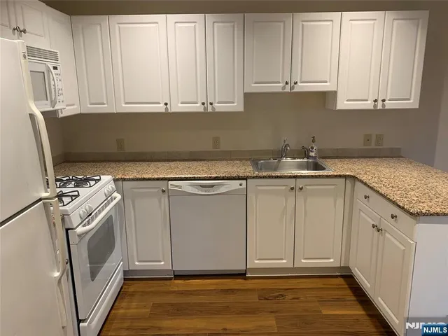 a view of a kitchen with sink and washer