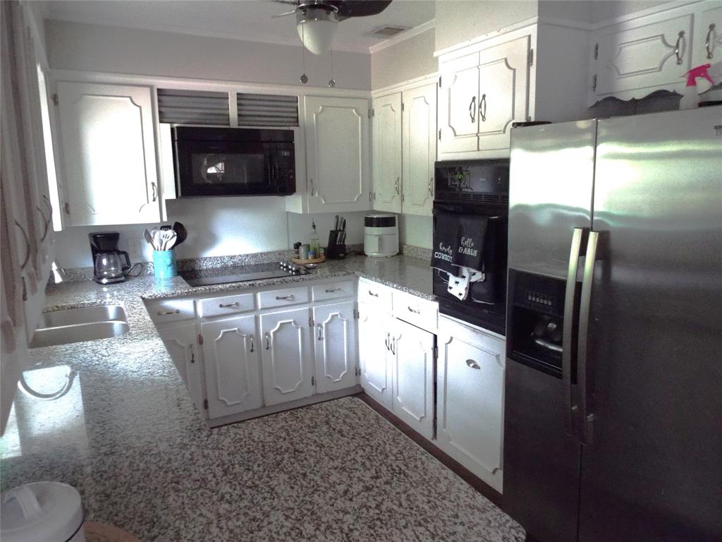 808 Shady Trail Athens, TX 75751 - Photo 14 of 22 a kitchen with stainless steel appliances granite countertop a refrigerator a stove a sink and a counter