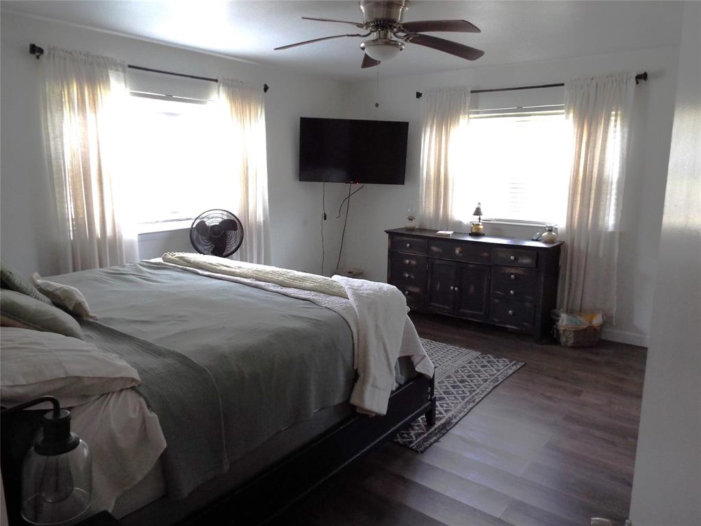 808 Shady Trail Athens, TX 75751 - Photo 18 of 22 a bedroom with a bed and a flat screen tv