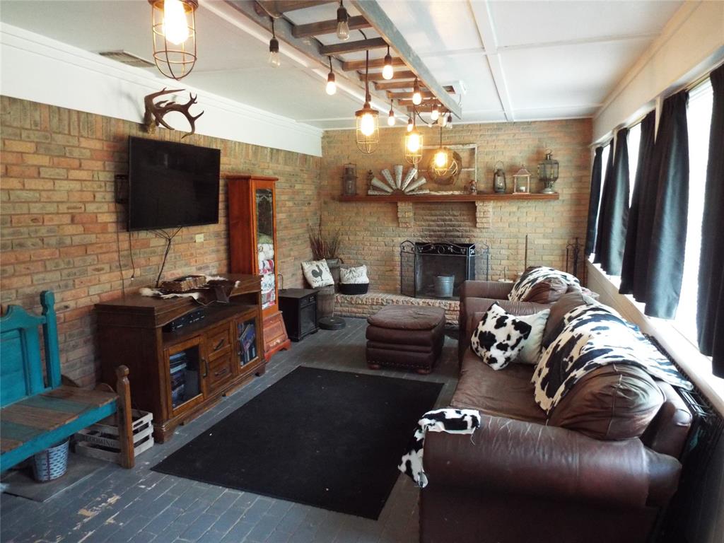 808 Shady Trail Athens, TX 75751 - Photo 20 of 22 a living room with furniture a flat screen tv and a fireplace
