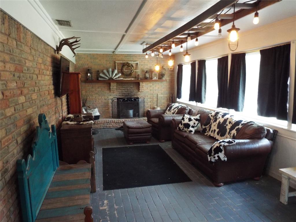 808 Shady Trail Athens, TX 75751 - Photo 21 of 22 a living room with furniture and a fireplace