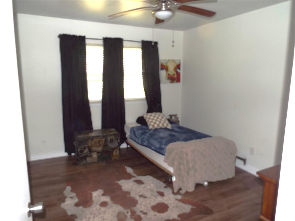 808 Shady Trail Athens, TX 75751 - Photo 5 of 22 a bedroom with a bed and wooden floor
