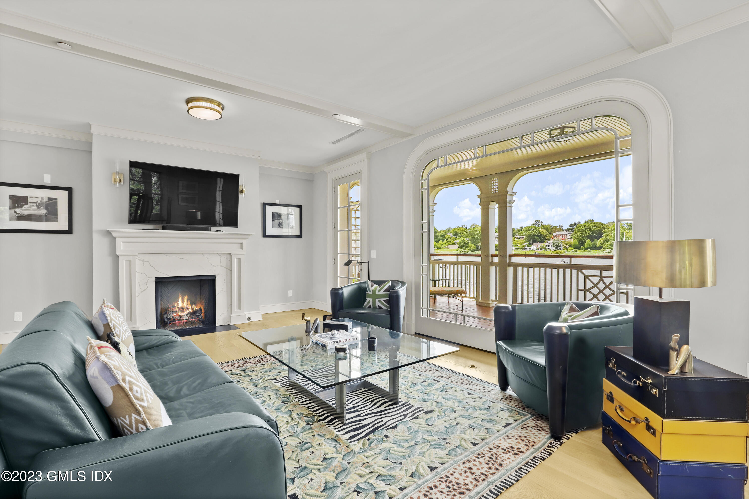 702 Steamboat Road, Unit 1 Greenwich, CT 06830 - Photo 7 of 25 a living room with furniture a flat screen tv and a fireplace