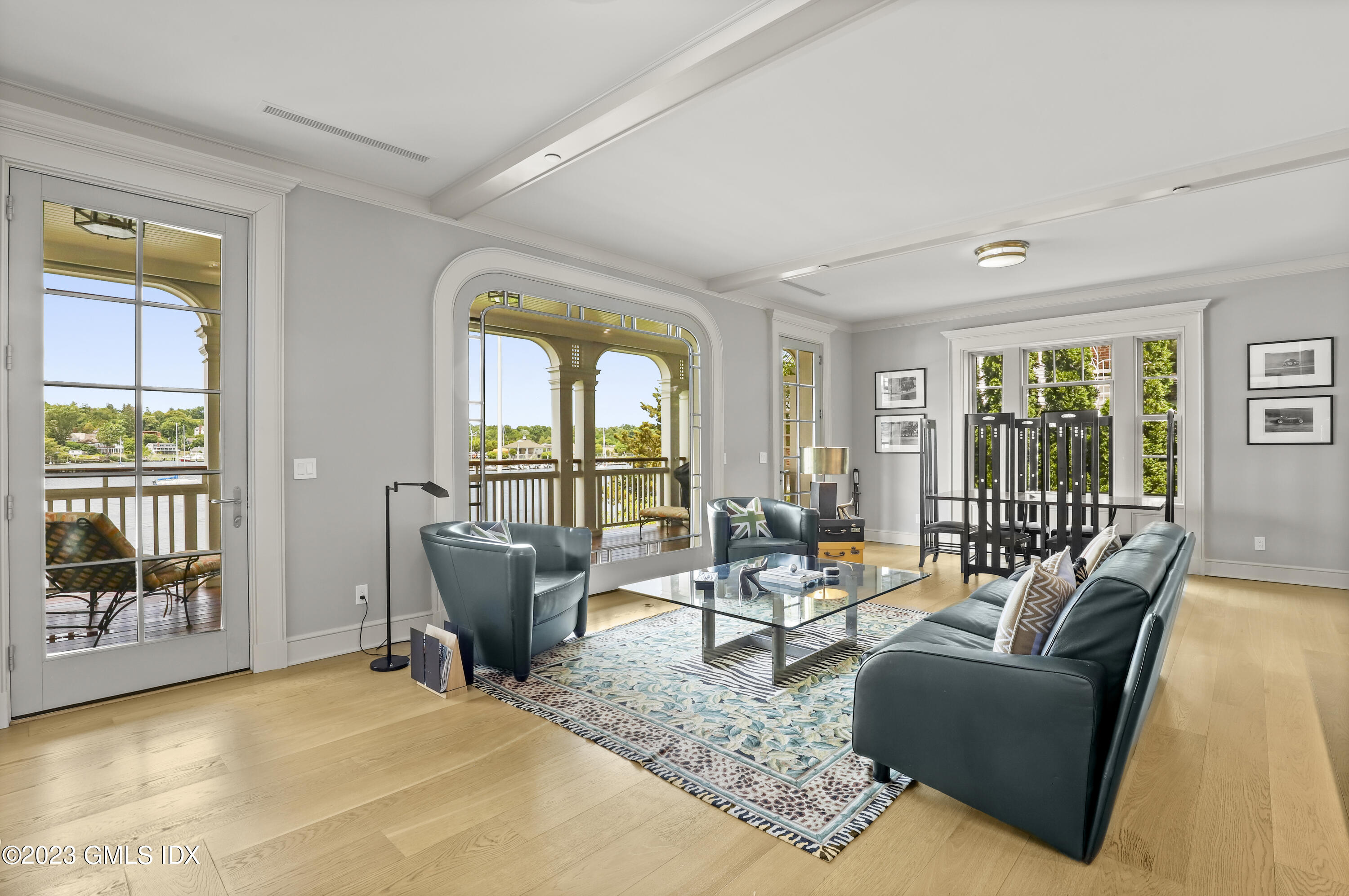702 Steamboat Road, Unit 1 Greenwich, CT 06830 - Photo 8 of 25 a living room with furniture and floor to ceiling windows