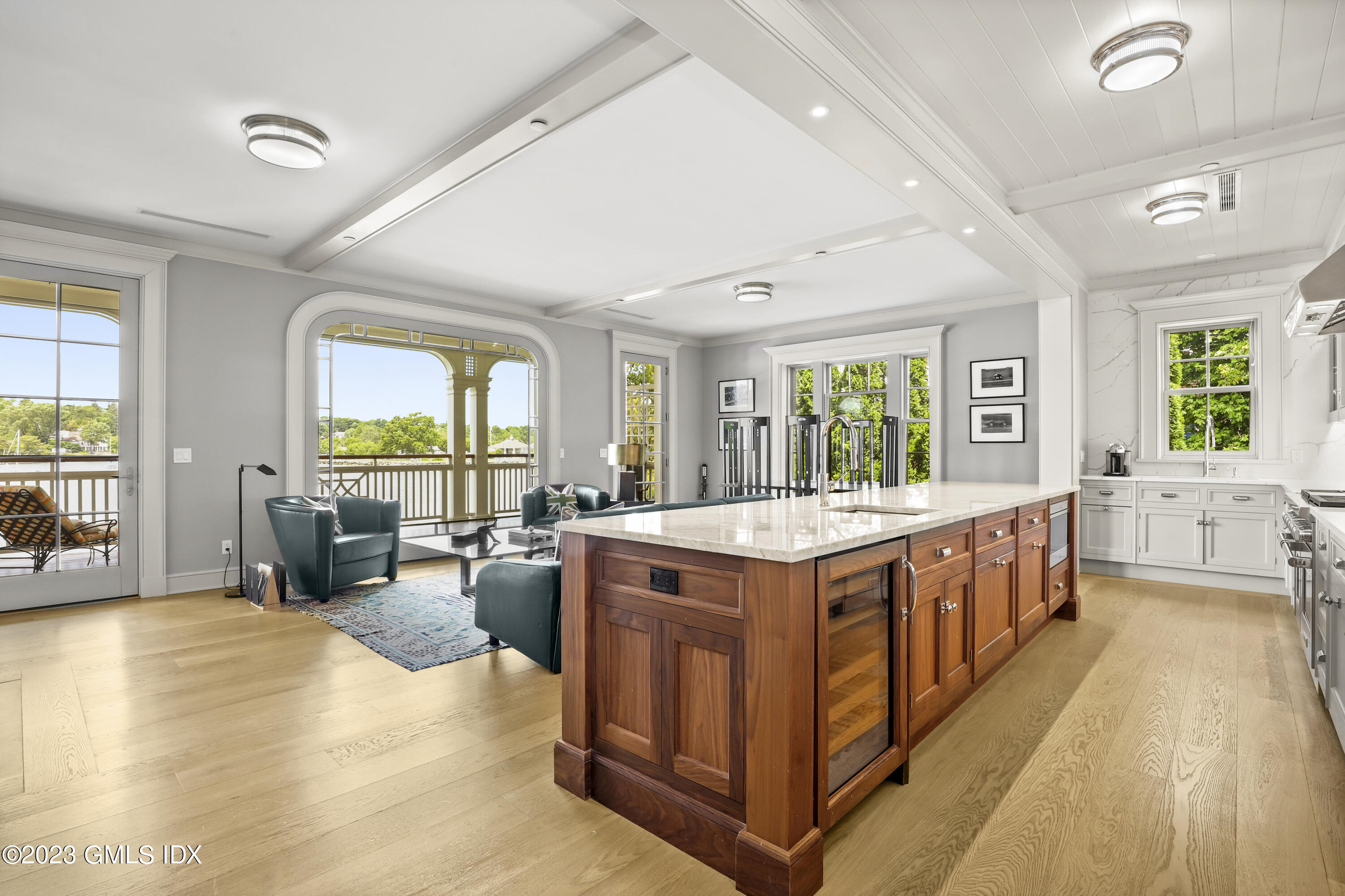 702 Steamboat Road, Unit 1 Greenwich, CT 06830 - Photo 10 of 25 a large kitchen with a large window a counter space wooden floor and stainless steel appliances