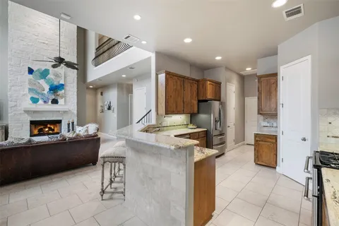 a kitchen with stainless steel appliances granite countertop wooden cabinets a stove top oven a sink and dishwasher