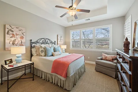 a bathroom with a granite countertop sink a toilet and a mirror
