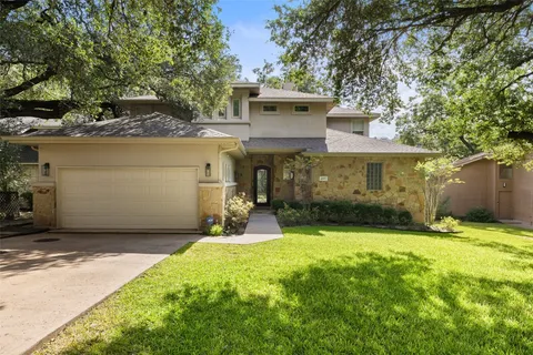 a view of a house with a yard and garage