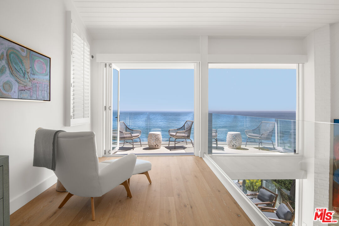 24134 Malibu Road Malibu, CA 90265 - Photo 17 of 39 a living room with furniture and a floor to ceiling window