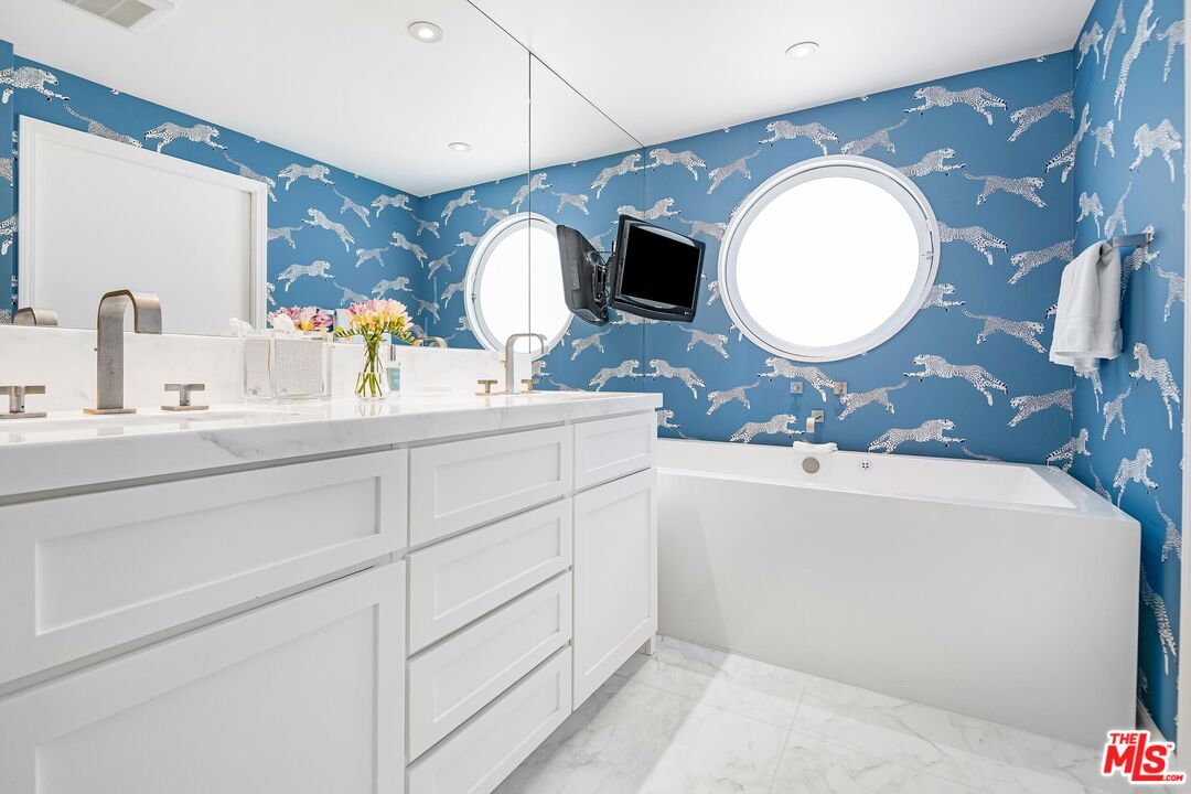 24134 Malibu Road Malibu, CA 90265 - Photo 19 of 39 a bathroom with a double vanity sink and a mirror
