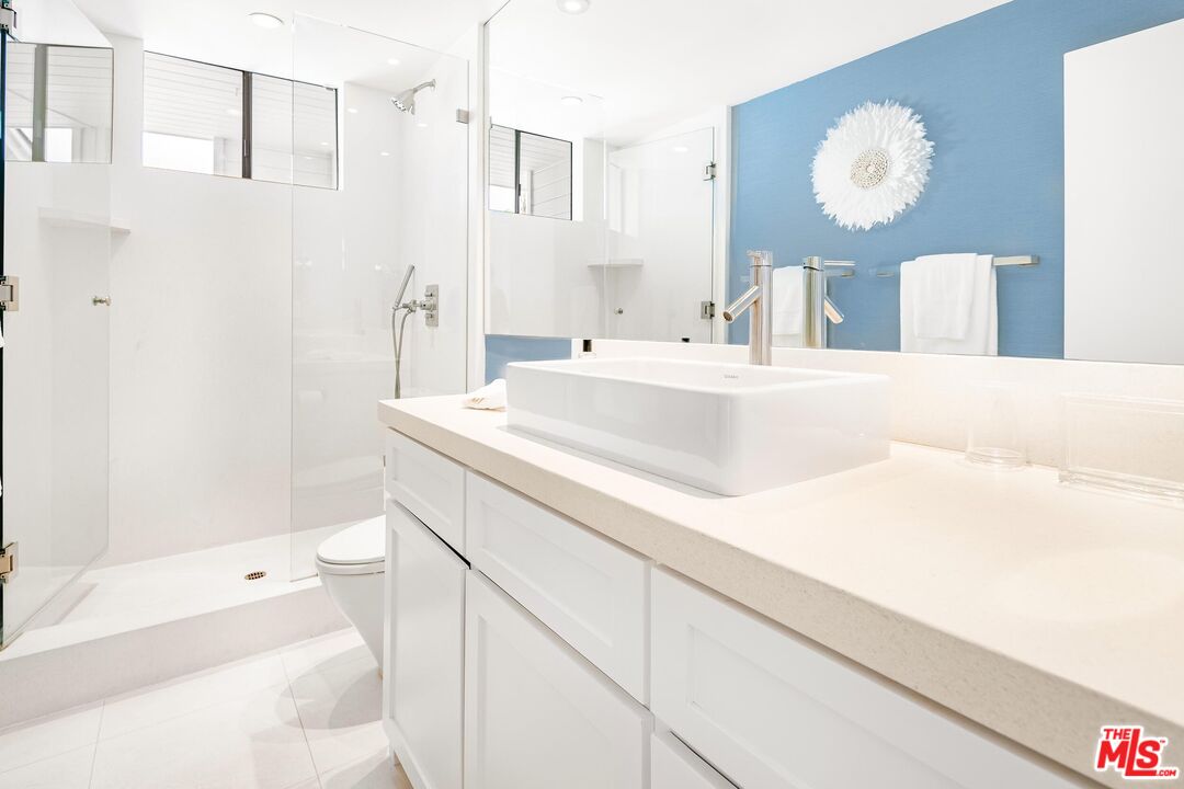 24134 Malibu Road Malibu, CA 90265 - Photo 22 of 39 a bath room with a sink vanity and a mirror