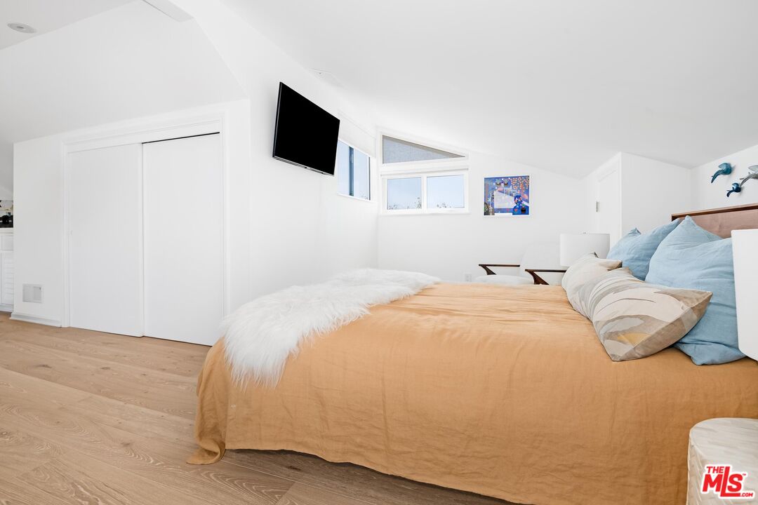 24134 Malibu Road Malibu, CA 90265 - Photo 24 of 39 a bedroom with a bed and a flat screen tv