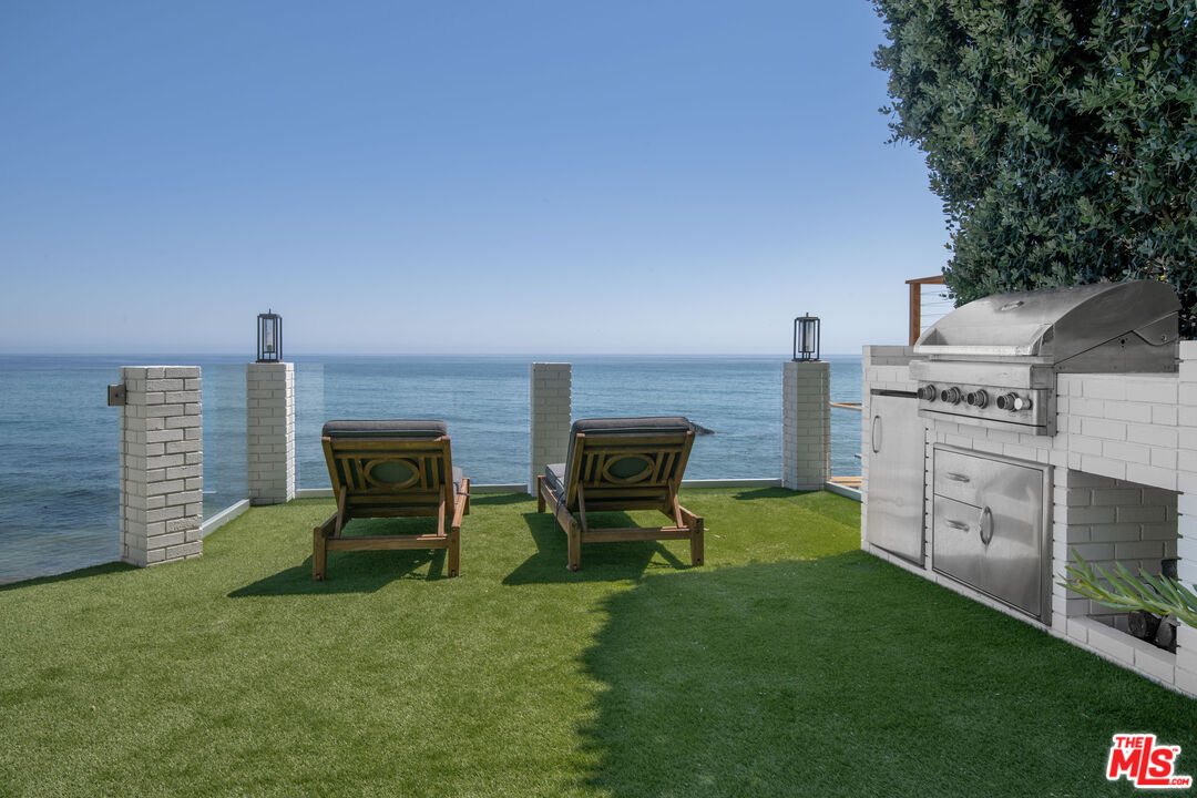 24134 Malibu Road Malibu, CA 90265 - Photo 30 of 39 a view of a chair and table in the garden