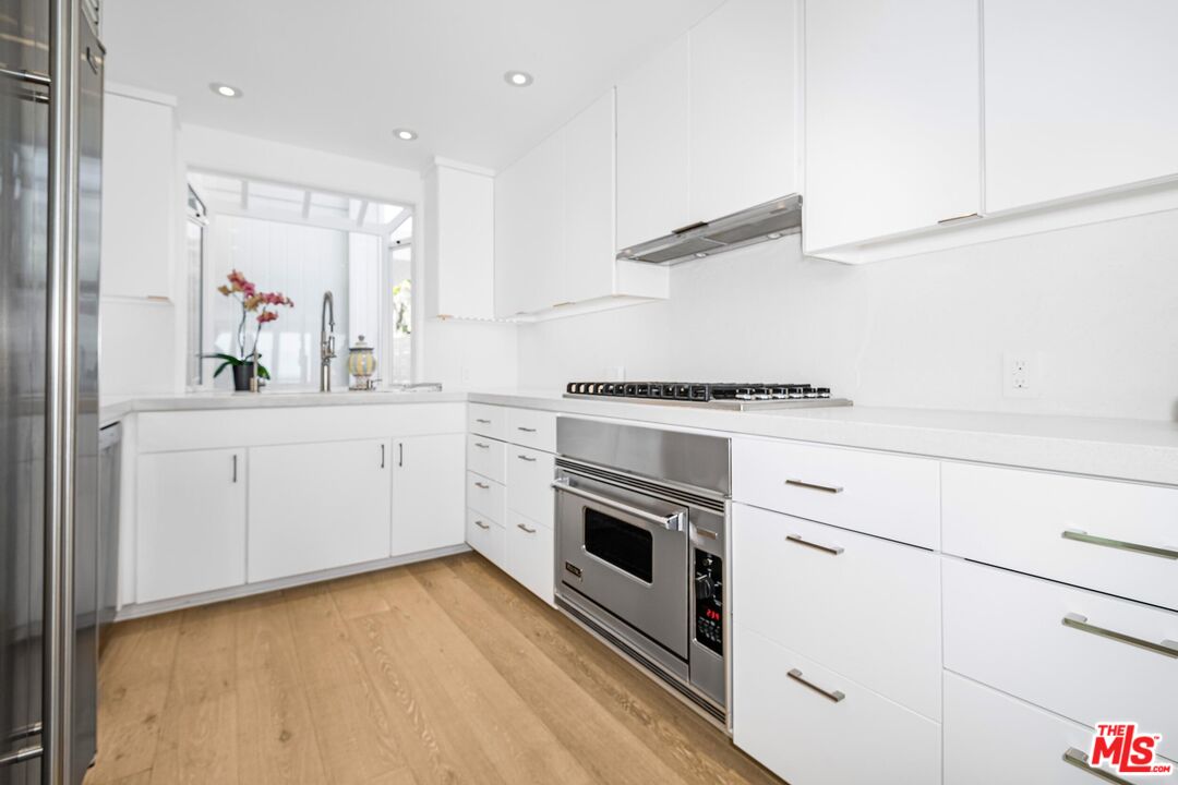 24134 Malibu Road Malibu, CA 90265 - Photo 8 of 39 a kitchen with a sink stove and cabinets