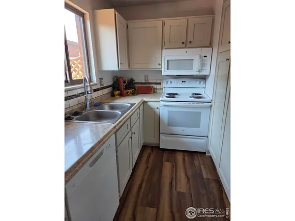 a kitchen with a sink cabinets and a window