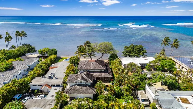 an aerial view of a house with a yard