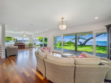 a room with pool table and windows