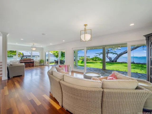 a room with pool table and windows