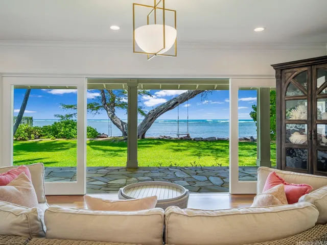an open kitchen with wooden floor and breakfast area