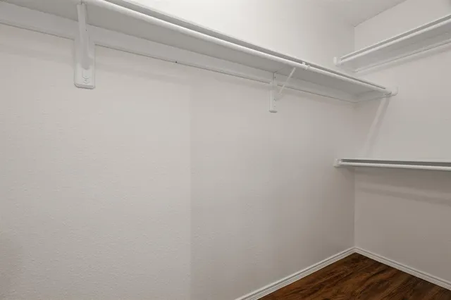 a bathroom with a granite countertop sink a toilet a mirror a bathtub and shower