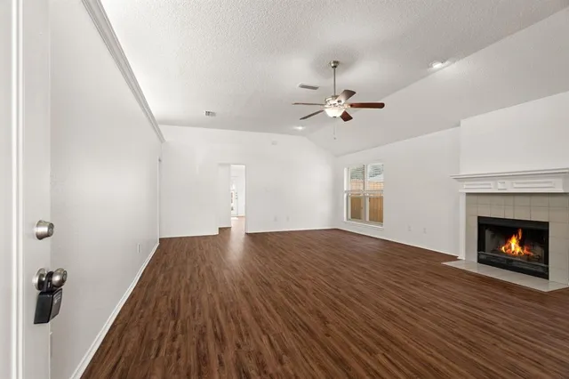 wooden floor in an empty room with a fireplace