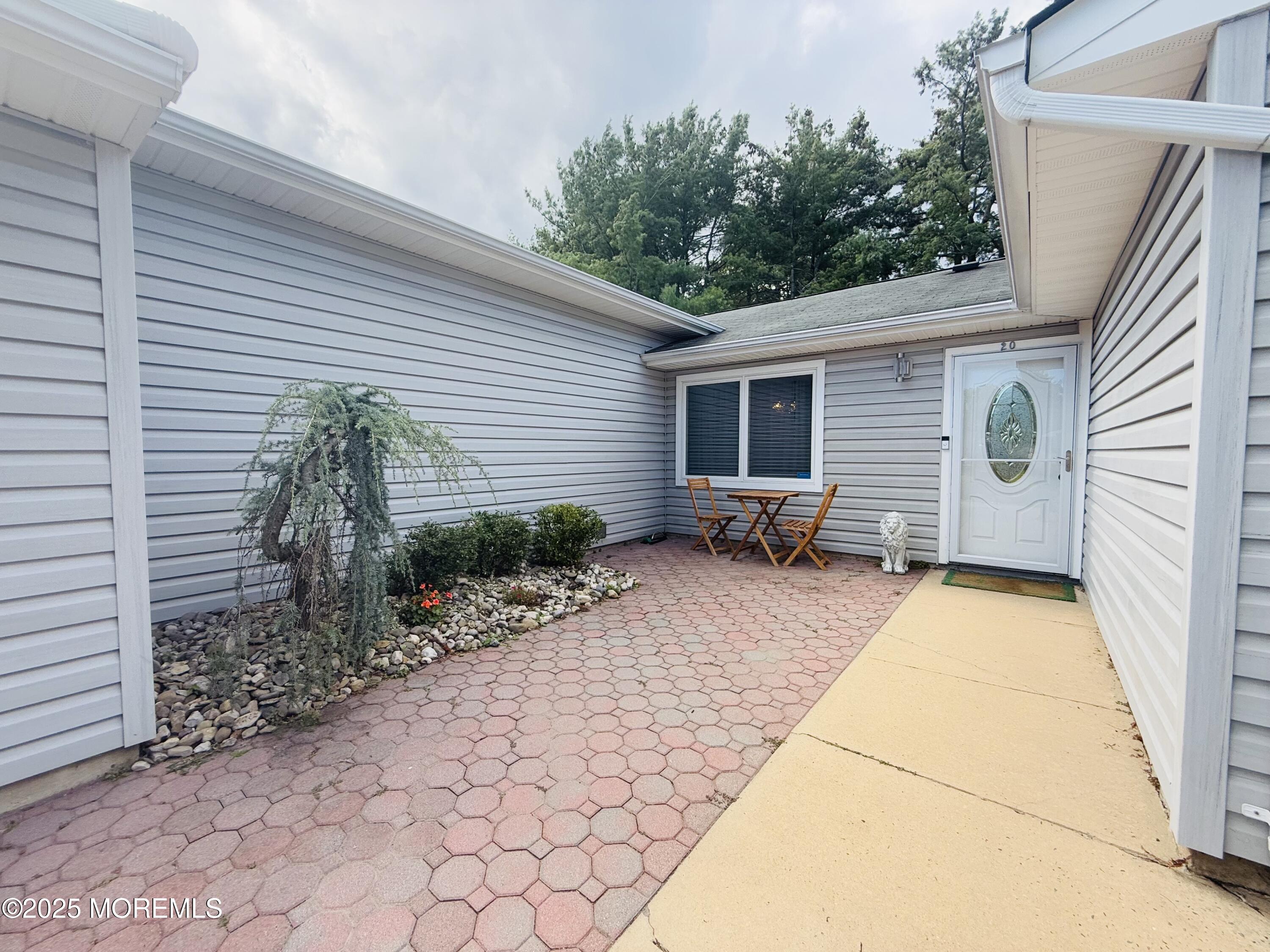 20 Long Road Freehold, NJ 07728 - Photo 3 of 20 a view of backyard with potted plants and a bench