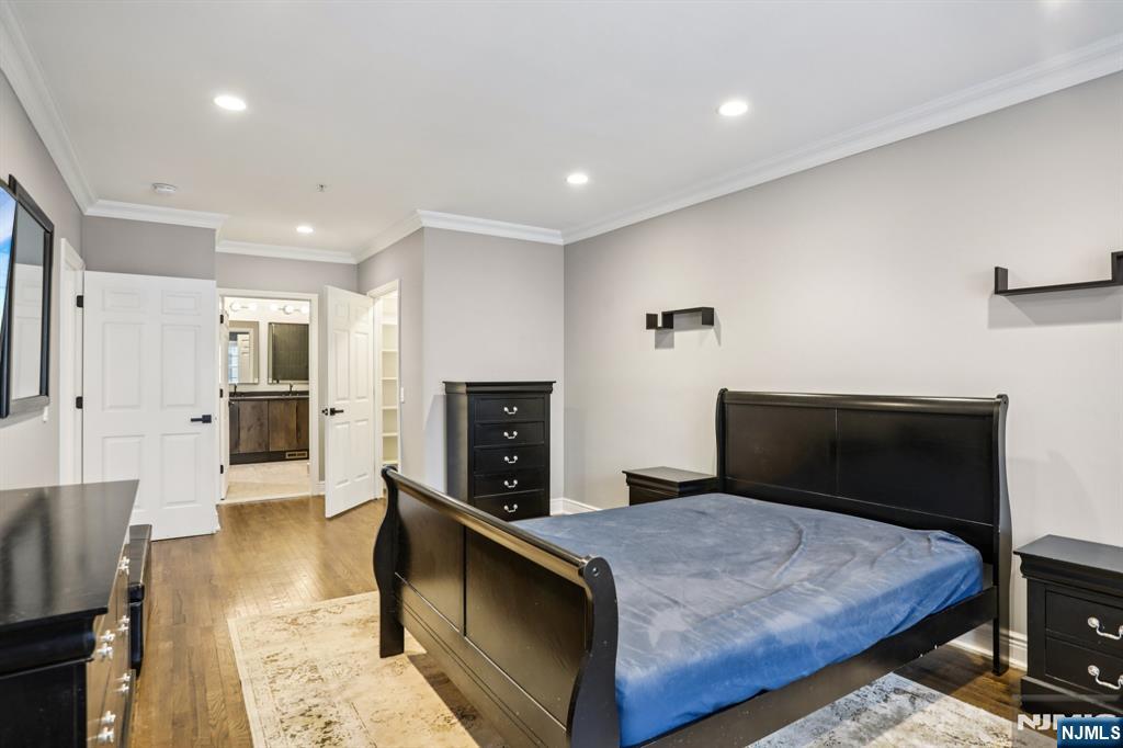 343 The Promenade, Unit 343 Edgewater, NJ 07020 - Photo 22 of 38 a bedroom with a bed and a fireplace