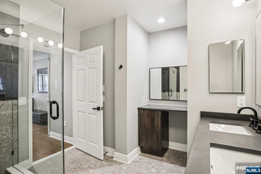 343 The Promenade, Unit 343 Edgewater, NJ 07020 - Photo 25 of 38 a bathroom with a sink and a mirror